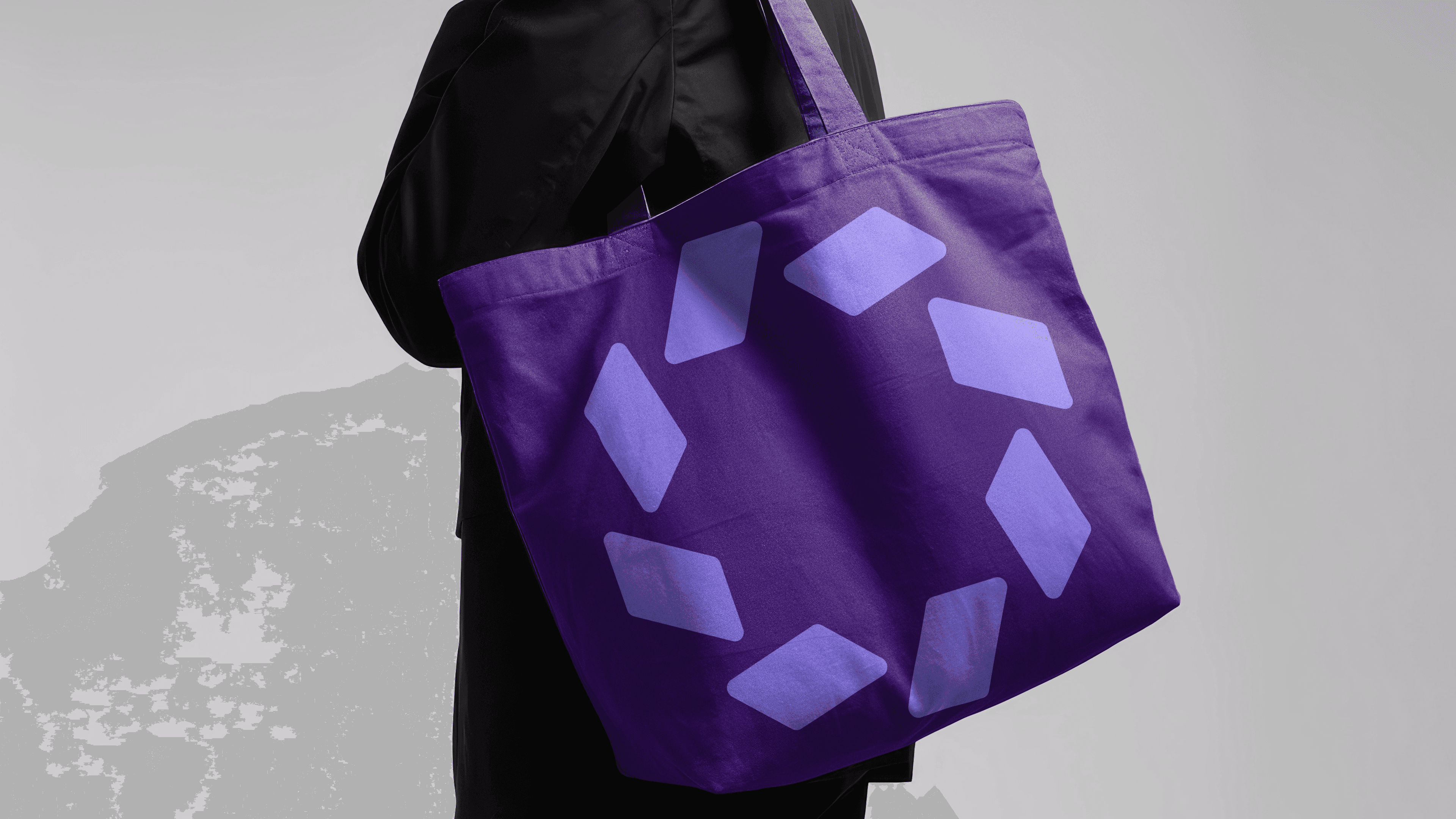 Branded tote bag with a purple geometric pattern